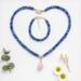 Matching Kumihimo necklace and bracelet set by Bead & Braid Collective, handmade blue beaded jewelry with rose quartz charm